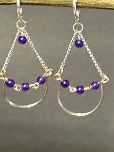 These are one of kind beautiful handmade purple amethyst chandelier dangle earrings. Artisan designed and handcrafted this unique structure.  Closing with sterling silver leverbacks, and hanging from a sterling silver chain. Total measurement is 2 1/2 inches long including sterling silver lever back earring wire. Purple Teardrop Chandelier Earrings As Gift, Handmade Purple Sterling Silver Chandelier Earrings, Handmade Purple Amethyst Chandelier Earrings, Purple Chandelier Earrings With Ear Wire As A Gift, Nickel-free Purple Dangle Chandelier Earrings, Handmade Amethyst Teardrop Chandelier Earrings, Teardrop Amethyst Chandelier Earrings For Jewelry Making, Handmade Teardrop Sterling Silver Chandelier Earrings, Purple Wire Wrapped Chandelier Drop Earrings