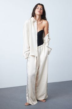 Pajama shirt and pants in softly draped satin. Shirt with a collar  concealed buttons at front  and yoke at back with box pleat. Open chest pocket and long sleeves with wide cuffs. Wide-cut pants with an elasticized drawstring waistband and diagonal side pockets. Satin Pyjamas, Linen Pajamas, Wide Trousers, Satin Pyjama Set, Satin Pajamas, Women Nightwear, Satin Shirt, Wide Cuff, Pajama Shirt