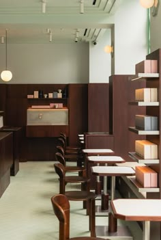 an empty restaurant with wooden tables and chairs