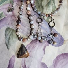 "*Genuine agate *Stainless steel  Semi precious stone jewelry set, necklace bracelet and earrings. Beautiful natural 6mm Botswana agate beads. Soothing earth tone colors.  Each bead is unique with its own pattern of lines.  The necklace is 18 inch, earrings have approximately a two inch drop, and the bracelet is 6-3/4\" with a 1-1/2\" extender chain, so will fit up to 8.25 inch wrist.  Visit my shop for more unique jewelry and artwork. ENTER MY ETSY SHOP HERE          GildedLilley.Etsy.com" Adjustable Jewelry Sets With Polished Round Beads, Adjustable Gemstone Beads Jewelry Sets As Gift, Adjustable Gemstone Beads Jewelry Sets For Gifts, Adjustable Jewelry Sets With Gemstone Round Beads, Adjustable Gemstone Beads Jewelry Sets With Round Beads, Adjustable Jewelry Sets With Round Gemstone Beads, Adjustable Hand Knotted Agate Necklace, Agate Multi-stone Jewelry Gift, Agate Stone Jewelry