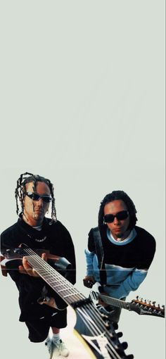 two men with dreadlocks are holding guitars and looking at the camera while wearing sunglasses