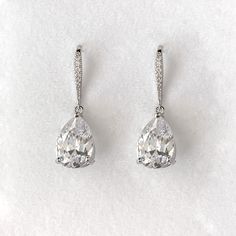 A simple and universally flattering teardrop shaped crystal drop earring is the perfect finishing touch on your wedding day. Our simulated diamonds are AAA+ quality for maximum sparkle. Length: 1 1/4", Width: 1/2" Stones measure 10mm x 14mm 8 carat total weight Carat total weight based on diamond equivalent Custom gift box and microfiber storage pouch included Simple Drop Earrings, Teardrop Diamond Cut Earrings For Formal Events, Formal Teardrop Diamond Cut Earrings, Classic Drop Diamond Earrings, Teardrop Diamond Earrings With Prong Setting For Formal, Teardrop Diamond Earrings With Prong Setting For Formal Occasions, Teardrop Diamond Earrings With Diamond Accents For Formal Occasions, Classic Teardrop Diamond Earrings For Formal Occasions, Classic Teardrop Diamond Cut Earrings