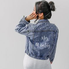 a woman wearing a denim jacket with the words miss winter written on it