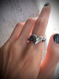 Love Struck Ring ⛓ 100% solid 316L stainless steel 💦 Waterproof 🚫 NO green skin. NO tarnish. NO rust 🖐 Sizes 5-11 available Edgy Adjustable Silver Rings, Edgy Metal Ring Gift, Unique Stainless Steel Promise Ring, Hypoallergenic Stainless Steel Promise Ring, Adjustable Gothic Stainless Steel Rings, Punk Style Sterling Silver Ring As Gift, Gothic Stainless Steel Ring As A Gift, Silver Tarnish Resistant Heart Ring Gift, Silver Tarnish-resistant Heart Ring For Gift