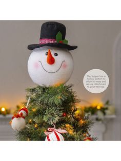 a snowman is sitting on top of a christmas tree