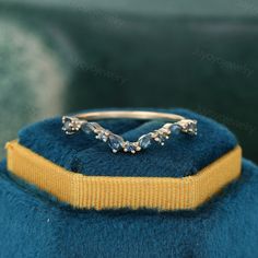 a close up of a ring on top of a blue hat