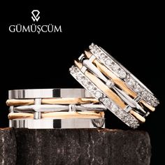 three bands of gold and silver are stacked on top of each other, with diamonds in the middle