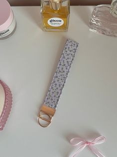 an assortment of items on a table including perfume, pacifier and other things to wear