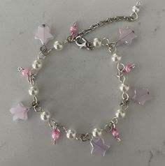 Handcrafted dainty silver/pink coloration charm bracelet with a variety of beads/charms ~ varieties include glass, pearlized & metal charms/beads.  Great gift to give or for yourself!  Fun to wear or give!  Perfect for daughter or granddaughter!  Adjustable length up to 8.5" Each bracelets is unique & individually handcrafted. Cheap Silver Kawaii Jewelry, Dainty Pink Jewelry With Dangling Charms, Pink Metal Jewelry With Dangling Beads, Pink Whimsical Metal Jewelry, Whimsical Pink Metal Jewelry, Nickel Free Pink Charm Bracelet, Adjustable Pink Nickel-free Charm Bracelet, Adjustable Nickel-free Pink Charm Bracelet, Nickel-free Pink Charm Bracelet