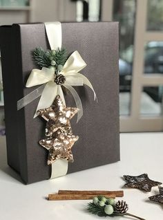 a christmas present box decorated with gold and silver stars