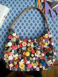 a handbag made out of buttons on a table