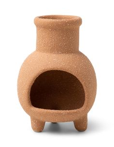 a small clay vase with a hole in the middle on a white background for decoration