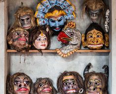 the shelves are filled with masks and other decorations