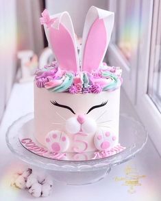 a cake decorated with bunny ears and flowers