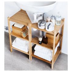 a wooden shelf with towels and other items on it