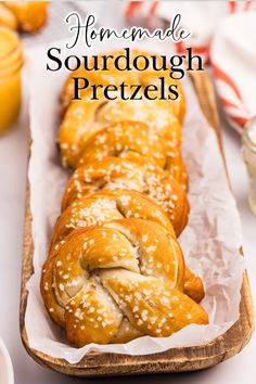 homemade sourdough pretzels in a wooden tray with text overlay that reads homemade sourdough pretzels