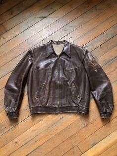 fantastic side synched leather jacket from the 1940s. this one has slight shoulder pads. lots of great zips.  Label: none Measurements: Pit to Pit: 23" Waist: 20" Length: 24" Sleeve Length: 24.5" Shoulder to Shoulder: 18" Condition: worn in as shown - someone took a chunk out of the lining for some reason?? SOLD AS FOUND *ALL SALES CONSIDERED FINAL -vintage is sold in "as-is" / "as-found" condition. we try to mention as best as possible any flaws noted but most of what we sell in this shop is wo Tan Jacket Coach 1941, Vintage Leather Outerwear With Zipper Closure, Vintage Leather Jacket With Zip Fly, Vintage Leather Jacket With Long Sleeves And Zip Fly, Vintage Brown Leather Jacket With Zipper Closure, Vintage Brown Outerwear With Zip Fly, Vintage Brown Leather Jacket With Zipper, Vintage Biker Jacket With Zip Fly For Fall, Vintage Brown Biker Jacket With Zipper Closure