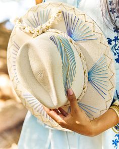 The wait is over! This hat is Ready to Ship and your order will be processed and shipped within 3-7 business days. Items with embroidery customization will be shipped within 2 weeks. Dyed White Palm Wide Brim Hat with Blue/Gold Feather Design Custom designed and hand made hats by artisans in San Jose Del Cabo, Mexico. These hats are one size fits most with an elastic band inside to add comfort and fit for all head sizes. Please note, all hats come with natural braid unless custom braid is purcha Shoes Makeover, Cowboy Hat Crafts, San Jose Del Cabo Mexico, Cowboy Hat Design, Hat Burning, Hat Bar, Custom Made Hats, Hat Aesthetic, Cabo Mexico