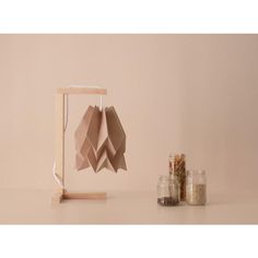 an origami sculpture sitting on top of a table next to jars and spices