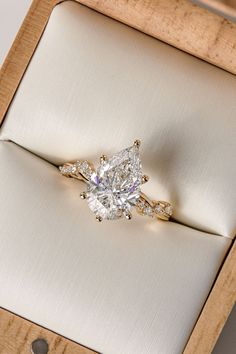 an engagement ring in a wooden box