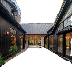 an empty walkway between two black buildings