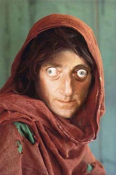 a man with eyes that look like he is wearing a red cloak over his head