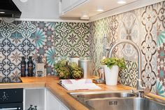 a kitchen with colorful tiles and wooden counter tops