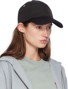 Water-repellent nylon- and cotton-blend twill cap in black. · Metal eyelets at crown · Logo hardware at face · Curved brim · Cinch fastening · Twill browband · Partial cotton twill lining · Logo-engraved silver-tone hardware Supplier color: Black Sporty Dad Hat With Curved Visor, Curved Visor Dad Hat For Sports, Black Waterproof Hat With Curved Brim, Black Waterproof Visor Hat, Black Waterproof Hats With Short Brim, Black Waterproof Hat With Short Brim, Waterproof Black Hats With Short Brim, Waterproof Black Nylon Hats, Adjustable Black Nylon Baseball Cap