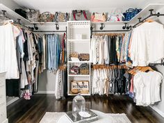 an organized closet with clothes and shoes