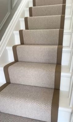 a set of stairs with beige carpet and white trim