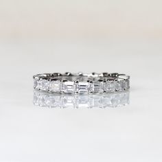 a white gold ring with baguetts of diamonds