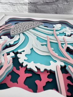 a paper cut out of an ocean scene with corals