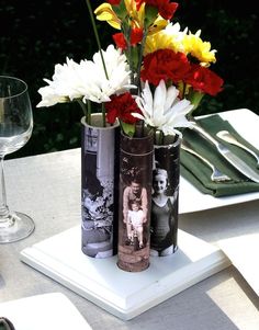 three vases with flowers in them sitting on a table