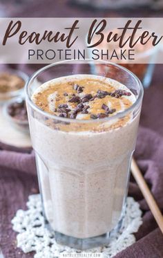 peanut butter protein shake in a glass on top of a doily with chocolate chips