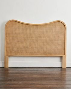 the headboard is made out of wood and has a beige fabric covering it's sides