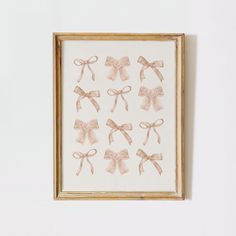 a framed painting with bows hanging on the wall