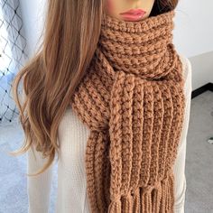 a mannequin wearing a brown knitted scarf