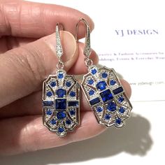 "A pair of something blue Gatsby wedding 1920s vintage style Art Deco bridal earrings with geometric details. These stunning, lightweight earrings are made of sparkly cubic zirconia with white gold silver rhodium plated hooks. Earrings are about 1 3/4\" (4.5cm) with hooks. View matching pieces or similar designs at https://etsy.me/2Mu6wjC See all geometric designs at https://etsy.me/2eKf6s8 View all something blue designs at https://etsy.me/1aLVWtA" Art Deco Crystal Drop Earrings For Wedding, Silver Art Deco Bridal Earrings For Party, Blue Art Deco Wedding Earrings, Blue Art Deco Jewelry For Party, Silver Gatsby Jewelry For Vintage Events, Vintage Bridal Earrings With Elegant Design, Blue Art Deco Jewelry For Evening, Art Deco Blue Cubic Zirconia Jewelry, Vintage Blue Earrings For Wedding