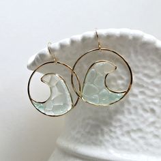 "Made to order. Important information on current production times may be found on the shop policies page or in the shop announcement. One of the newest additions to my sea glass and resin hoop earring line: for the bohemian beach babe. The sea glass has been gathered from beaches across the Hawaiian islands. The first six pictures are in gold filled, and the last two are in sterling silver. ~ sea glass, resin ~ gold filled, sterling silver, or rose gold filled wire ~ approximately 1 1/2 inches ( Everyday Round Glass Jewelry, Modern Glass Jewelry For Summer, Modern Gold Jewelry For The Beach, Circle Earrings With Ear Wire For Beach, Unique Beach Glass Jewelry, Unique Glass Jewelry For Beach, Circular Summer Beach Jewelry, Summer Beach Circular Jewelry, Summer Beach Circle Jewelry