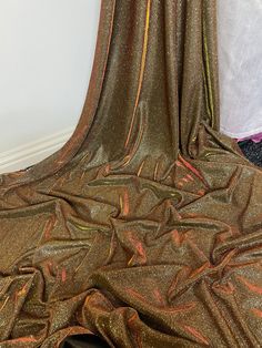 a close up view of a gold colored fabric with metallic foil on the top and bottom