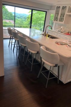 a large kitchen with an island and lots of counter space in front of the sliding glass doors