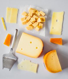 several different types of cheese on a white surface