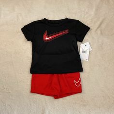 Nike Baby Boys Outfit Size 18 Months. Short Sleeve Shirt And Shorts. Black Shirt And Red Shorts. Brand New! Nike Black Summer Sets, Nike Red Playwear Sets, Baby Clothes Nike, Nike Toddler Boy Outfits, Baby Adidas Outfits Boys, Nike T Shirts Boys, Baby Boys Outfit, Toddler Nike Outfits Baby Boy, Little Boy Outfits