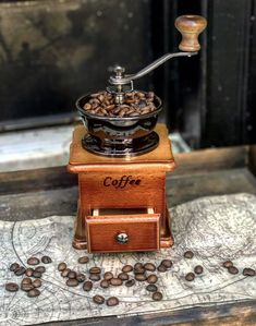 an old coffee grinder with beans on it