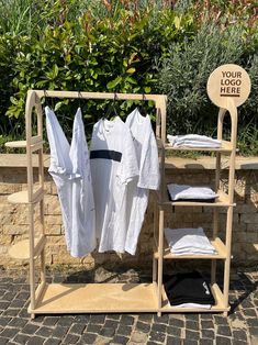 clothes are hung on racks outside in the sun