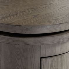 a close up view of the top of a round table with wood grained finish