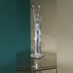 a crystal vase sitting on top of a glass table