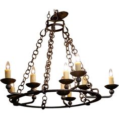 a chandelier with five candles hanging from it's center and four arms