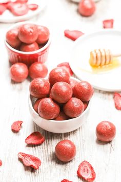 some red candies are in small bowls on a table