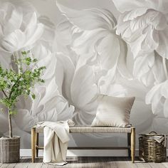 a white flowered wallpaper in a living room with a couch and potted plant